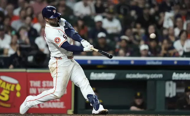 Houston Astros' Christian Walker (8) hits a home run during the sixth inning of a baseball game against the San Diego Padres in Houston, Saturday, April 19, 2025. Isaac Paredes also scored. (AP Photo/Ashley Landis)