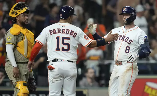 Houston Astros' Christian Walker (8) celebrates with Paredes (15) after they both scored off of a home run hit by Walker during the sixth inning of a baseball game against the San Diego Padres in Houston, Saturday, April 19, 2025. (AP Photo/Ashley Landis)
