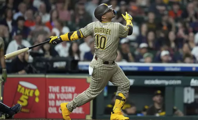 San Diego Padres' Yuli Gurriel flies out during the ninth inning of a baseball game against the Houston Astros in Houston, Saturday, April 19, 2025. (AP Photo/Ashley Landis)