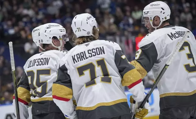 Vegas Golden Knights' Victor Olofsson (95), William Karlsson (71) and Brayden McNabb (3) celebrate McNabb's goal against the Vancouver Canucks during the second period of an NHL hockey game in Vancouver, on Wednesday, April 16, 2025. (Darryl Dyck/The Canadian Press via AP)