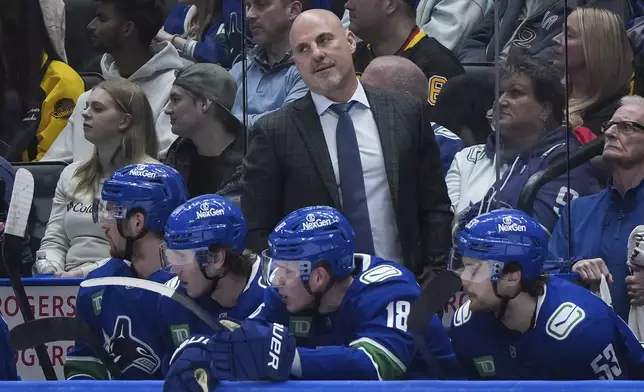 Vancouver Canucks head coach Rick Tocchet stands on the bench during the first period of an NHL hockey game against the Vegas Golden Knights in Vancouver, on Wednesday, April 16, 2025. (Darryl Dyck/The Canadian Press via AP)