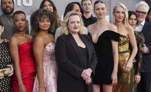 O-T Fagbenle, from left, Samira Wiley, D'Arcy Carden, Elisabeth Moss, Amanda Brugel, Jonathan Watton, Yvonne Strahovski, Ever Carradine, Nina Kiri, and Bradley Whitford arrive at the premiere of the sixth season of "The Handmaid's Tale" on Wednesday, April 2, 2025, at TCL Chinese Theatre in Los Angeles. (Photo by Jordan Strauss/Invision/AP)
