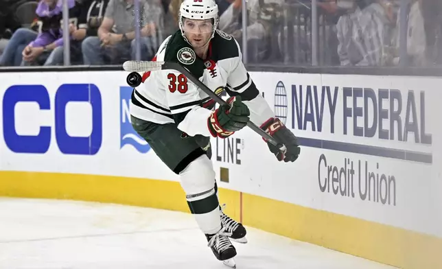 Minnesota Wild right wing Ryan Hartman (38) handles the puck against the Vegas Golden Knights during the first period of Game 2 of a first-round NHL hockey playoff series Tuesday, April 22, 2025, in Las Vegas. (AP Photo/David Becker)