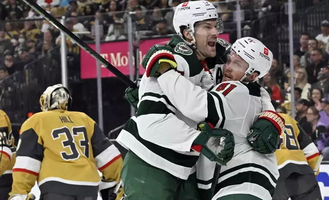 Minnesota Wild left wing Marcus Foligno, left, and center Gustav Nyquist (41) celebrate Foligno's goal against the Vegas Golden Knights during the first period of Game 2 of a first-round NHL hockey playoff series Tuesday, April 22, 2025, in Las Vegas. (AP Photo/David Becker)
