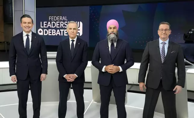 Conservative Leader Pierre Poilievre, from left, Liberal Leader Mark Carney, New Democratic Party Leader Jagmeet Singh, and Bloc Quebecois Leader Yves-Francois Blanchet, take part in a group photo prior participating in the English-language federal leaders' debate, in Montreal, Thursday, April 17, 2025. (Adrian Wyld/The Canadian Press via AP)