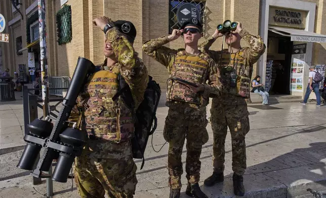 Italian army soldiers carrying an anti drone gun patrol the area in front of St. Peter's Square before a rosary prayer for the late Pope Francis, in Rome Tuesday, April 22, 2025. (AP Photo/Bernat Armangue)