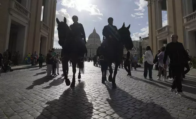 Horse mounted police patrol the area next to St. Peter's Square at the Vatican, Thursday April 24, 2025. (AP Photo/Markus Schreiber)