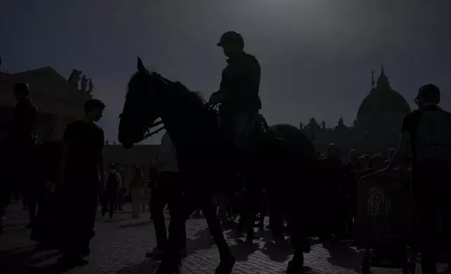 Horse-mounted police patrol St. Peter's Square at the Vatican after Cardinal Camerlengo Kevin Joseph Farrell announced the death of Pope Francis, Monday, April 21, 2025. (AP Photo/Alessandra Tarantino)
