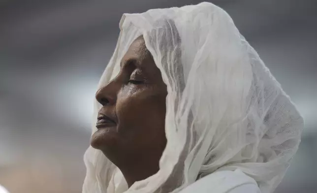 A congregant of the Re'ese Adbarat Debre Selam Kidist Mariam Church, an Ethiopian Orthodox Tewahedo church, stands during a service in Washington, D.C., Saturday, April 5, 2025. (AP Photo/Jessie Wardarski)