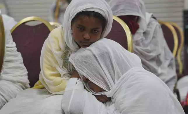 Congregants pray during a service at Re'ese Adbarat Debre Selam Kidist Mariam Church, an Ethiopian Orthodox Tewahedo church, in Washington, D.C., Saturday, April 5, 2025. (AP Photo/Jessie Wardarski)