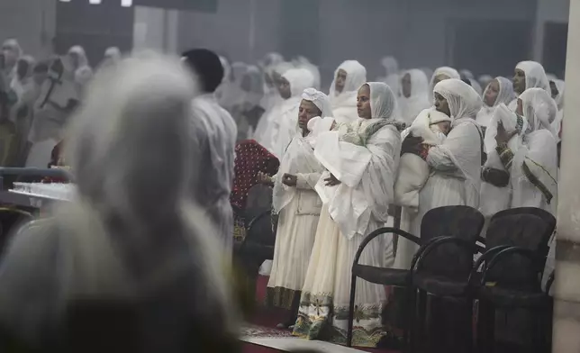Congregants stand to receive Communion at Re'ese Adbarat Debre Selam Kidist Mariam Church, an Ethiopian Orthodox Tewahedo church, in Washington, D.C., Saturday, April 5, 2025. (AP Photo/Jessie Wardarski)
