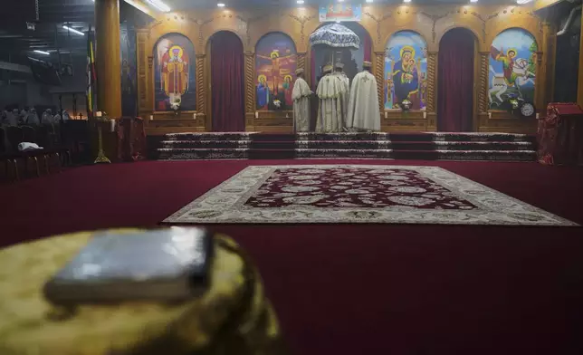 The kesis, or priest, recites the liturgy during service at Re'ese Adbarat Debre Selam Kidist Mariam Church, an Ethiopian Orthodox Tewahedo church, in Washington, D.C., Saturday, April 5, 2025. (AP Photo/Jessie Wardarski)