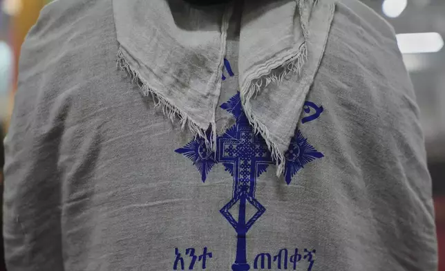 A congregant wears a netela, a white scarf-like cotton cloth, during a service at the Worshippers at Re'ese Adbarat Debre Selam Kidist Mariam Church, an Ethiopian Orthodox Tewahedo church, in Washington, D.C., Saturday, April 5, 2025. (AP Photo/Jessie Wardarski)