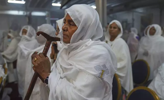 A worshipper holds a prayer staff during a service at Re'ese Adbarat Debre Selam Kidist Mariam Church, an Ethiopian Orthodox Tewahedo church, in Washington, D.C., Saturday, April 5, 2025. (AP Photo/Jessie Wardarski)
