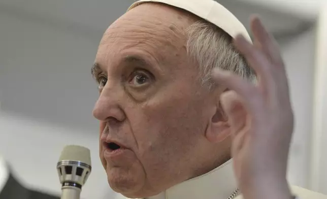 FILE - Pope Francis talks about gays saying he wouldn't judge priests for their sexual orientation in a remarkably open and wide-ranging news conference aboard the papal flight on the journey back from Brazil, on July 29, 2013. (AP Photo/Luca Zennaro, Pool, file)