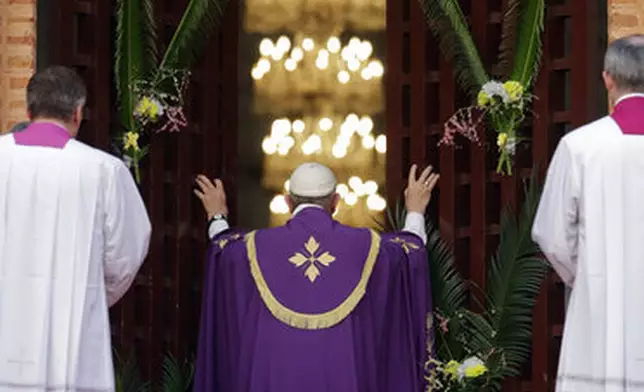 FILE - Pope Francis opens the holy door of the Bangui cathedral, Central African Republic, Sunday, Nov. 29, 2015. (AP Photo/Andrew Medichini, file)