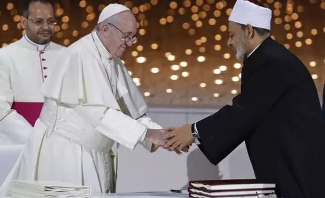 FILE - Pope Francis greets Sheikh Ahmed el-Tayeb, the grand imam of Egypt's Al-Azhar, after an Interreligious meeting at the Founder's Memorial in Abu Dhabi, United Arab Emirates, Wednesday, Feb. 4, 2015. (AP Photo/Andrew Medichini, file)