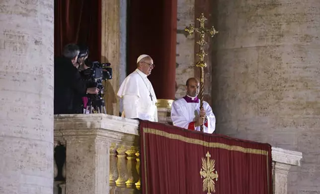 FILE - Argentine Cardinal Jorge Bergoglio, who chose the name of Pope Francis, looks out to the crowd from the central balcony of St. Peter's Basilica after being elected 266th pontiff of the Roman Catholic Church, at the Vatican, Wednesday, March 13, 2013. (AP Photo/Luca Bruno, file)