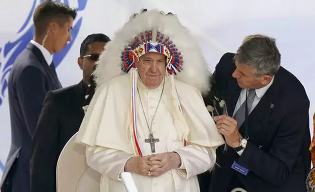 FILE - Pope Francis dons a headdress that was gifted to him during a visit with Indigenous peoples at Maskwaci, the former Ermineskin Residential School, Monday, July 25, 2022, in Maskwacis, Alberta. (AP Photo/Eric Gay, File)