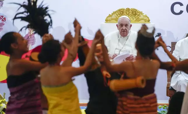 FILE - Pope Francis looks at traditional dancers as he arrives at the Centro de Convenções for a meeting with youths, in Díli, East Timor, Wednesday, Sept. 11, 2024. (AP Photo/Gregorio Borgia, file)