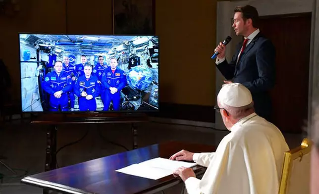 FILE - Pope Francis connects to the crew aboard the International Space Station from the Vatican, Thursday, Oct. 26, 2017. (L'Osservatore Romano/Pool Photo via AP, File)