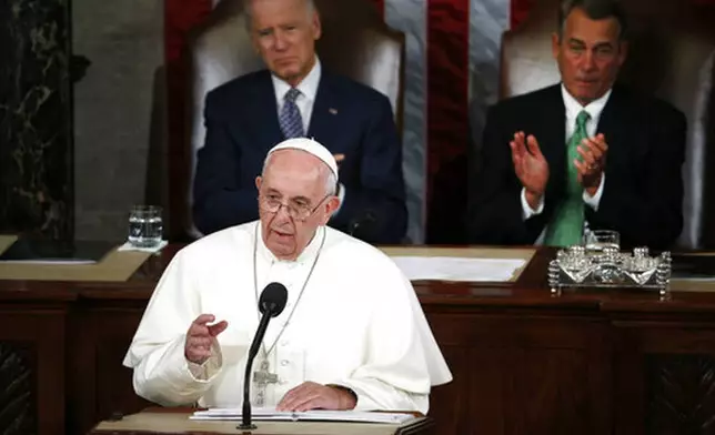 FILE - Pope Francis addresses a joint meeting of Congress on Capitol Hill in Washington, Thursday, Sept. 24, 2015. Listening behind the pope are then Vice President Joe Biden and House Speaker John Boehner of Ohio. (AP Photo/Carolyn Kaster, file)