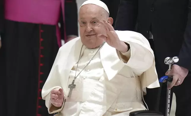 FILE - Pope Francis waves as he arrives for his weekly general audience in the Paul VI Hall, at the Vatican, Wednesday, Feb. 12, 2025. (AP Photo/Alessandra Tarantino, file)