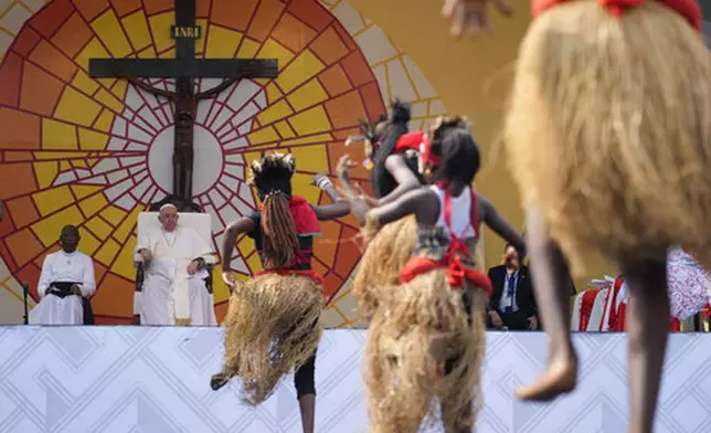 FILE - Pope Francis, second from left, looks at traditional dancers performing at the Martyrs' Stadium In Kinshasa, Democratic Republic of Congo, Thursday, Feb. 2, 2023. (AP Photo/Gregorio Borgia, File)