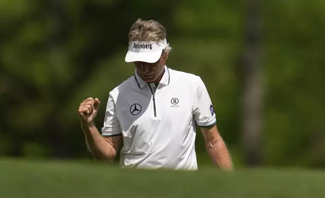 Bernhard Langer, of Germany, celebrates after his shot on the 12th hole during the second round at the Masters golf tournament, Friday, April 11, 2025, in Augusta, Ga. (AP Photo/Ashley Landis)