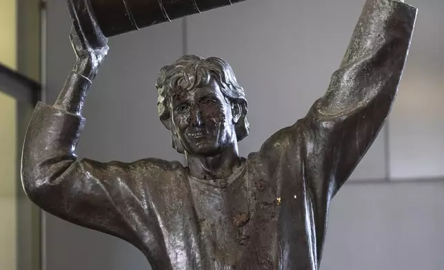 The Wayne Gretzky statue outside of Rogers Place, home of the NHL hockey team Edmonton Oilers, is covered with excrement after it was vandalized, in Edmonton, Alberta, Friday March 21, 2025. (Jason Franson/The Canadian Press via AP)