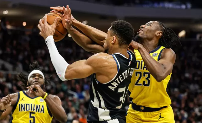 Milwaukee Bucks' Giannis Antetokounmpo (34) grabs a rebound against the Indiana Pacers' Aaron Nesmith during the first half of Game 4 of a first-round NBA basketball playoff series Sunday, April 27, 2025, in Milwaukee. (AP Photo/Jeffrey Phelps)