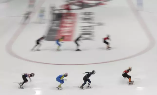 Athletes compete during a men's team relay quarterfinals of the ISU Short Track World Tour, Milan Cortina 2026 Winter Olympics event, in Milan, Italy, Friday, Feb. 14, 2025. (AP Photo/Luca Bruno)