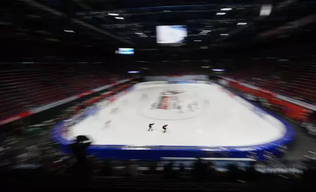 Athletes compete during a mixed team relay quarterfinals of the ISU Short Track World Tour, Milan Cortina 2026 Winter Olympics test event, in Milan, Italy, Friday, Feb. 14, 2025. (AP Photo/Luca Bruno)