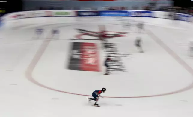 Athletes compete during a men's team relay quarterfinals of the ISU Short Track World Tour, Milan Cortina 2026 Winter Olympics test event, in Milan, Italy, Friday, Feb. 14, 2025. (AP Photo/Luca Bruno)