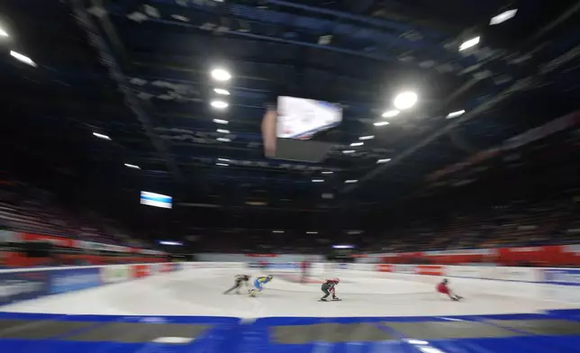 Athletes compete during men's preliminaries round of the ISU Short Track World Tour, Milan Cortina 2026 Winter Olympics test event, in Milan, Italy, Friday, Feb. 14, 2025. (AP Photo/Luca Bruno)
