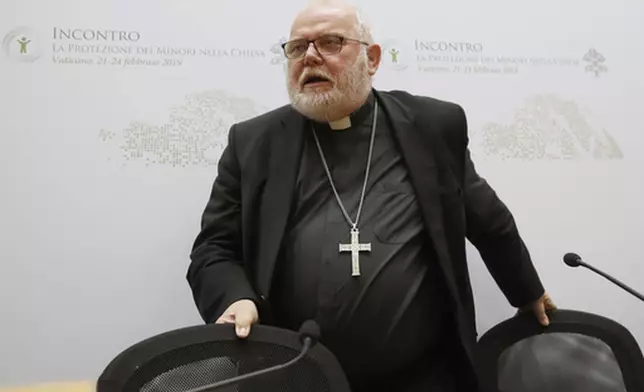 FILE - In this Saturday, Feb. 23, 2019 file photo Cardinal Reinhard Marx, the archbishop of Munich and Freising, leaves at the end of a media briefing during a four-day sex abuse summit called by Pope Francis in Rome. (AP Photo/Alessandra Tarantino, file)