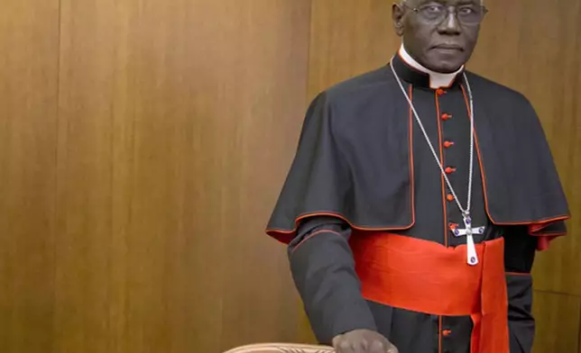 FILE - Cardinal Robert Sarah, prefect of the Congregation for Divine Worship and the Discipline of the Sacraments, arrives for the presentation of Cardinal Raymond Leo Burke's book Divine Love Made Flesh, in Rome, Wednesday, Oct. 14, 2015. (AP Photo/Andrew Medichini, File)
