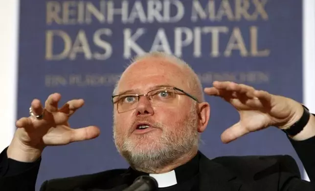 FILE - Munich and Freising Archbishop Reinhard Marx presents his new book 'The Capital' in Munich, southern Germany, Wednesday, Oct. 29, 2008. (AP Photo/Matthias Schrader)