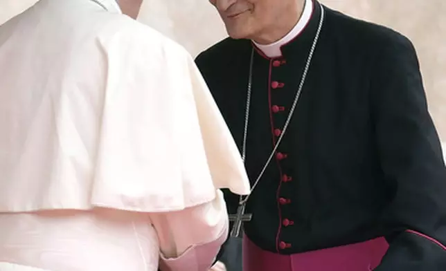 FILE - Pope Francis, left, speaks to Archbishop Matteo Maria Zuppi during his visit to Bologna, Italy, Oct. 1, 2017. (L'Osservatore Romano/Pool photo via AP, file)