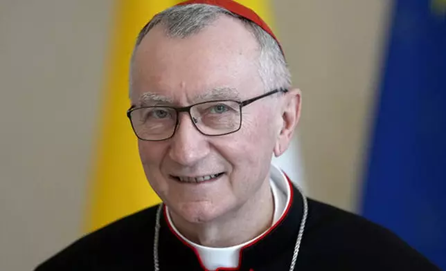 FILE - Vatican Secretary of State Cardinal Pietro Parolin smiles as he is welcomed by German President Frank-Walter Steinmeier for a meeting at the Bellevue palace in Berlin, Germany, Tuesday, June 29, 2021. (AP Photo/Michael Sohn, file)