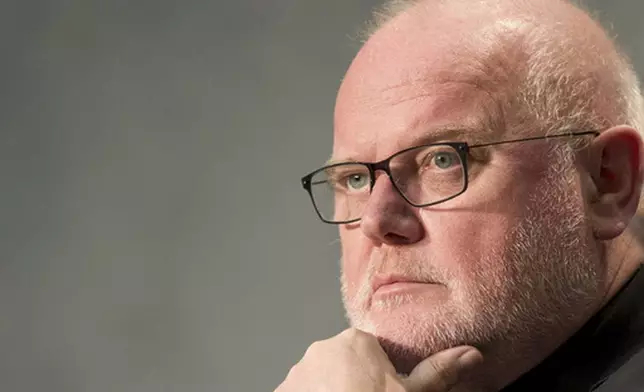 FILE - German Cardinal Reinhard Marx attends a press conference by Vatican spokesman Rev. Federico Lombardi at the Vatican's press center, Wednesday, Oct. 21, 2015. (AP Photo/Andrew Medichini, File)