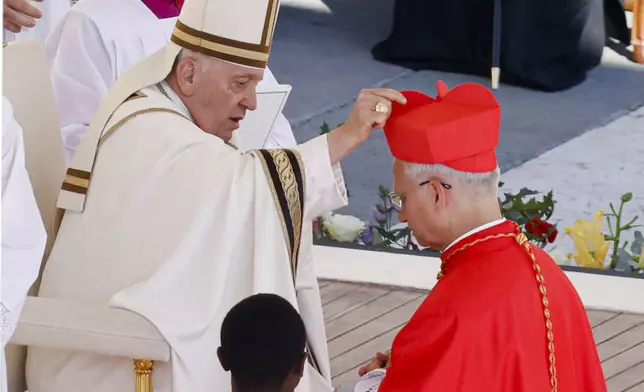 FILE - Newly elected Cardinal Robert Francis Prevost, Prefect of the Dicastery for Bishops, right, receives his biretta from Pope Francis as he is elevated in St. Peter's Square at the Vatican, Saturday, Sept. 30, 2023. (AP Photo/Riccardo De Luca, file)