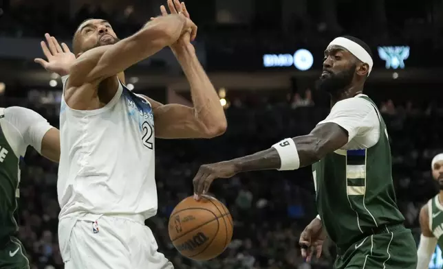 Milwaukee Bucks' Bobby Portis, right, strips the ball from Minnesota Timberwolves' Rudy Gobert during the second half of an NBA basketball game Tuesday, April 8, 2025, in Milwaukee. (AP Photo/Aaron Gash)