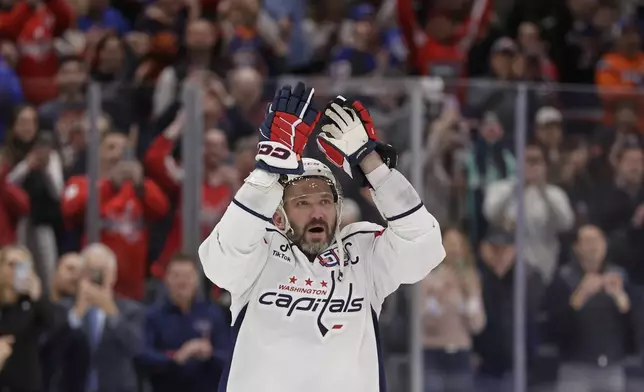 Washington Capitals left wing Alex Ovechkin (8) celebrates after scoring his 895th career goal during the second period of an NHL hockey game against New York Islanders in Elmont, N.Y., Sunday, April 6, 2025. (AP Photo/Adam Hunger)