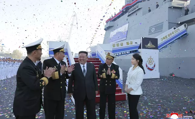 In this photo provided by the North Korean government, its leader Kim Jong Un, center, and his daughter, right, attend a ceremony to unveil a new naval destroyer at a western port in Nampo, North Korea, Friday, April 25, 2025. Independent journalists were not given access to cover the event depicted in this image distributed by the North Korean government. The content of this image is as provided and cannot be independently verified. Korean language watermark on image as provided by source reads: "KCNA" which is the abbreviation for Korean Central News Agency. (Korean Central News Agency/Korea News Service via AP)