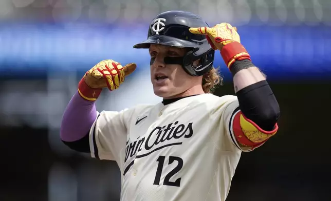Minnesota Twins' Harrison Bader (12) gestures after hitting a single during the third inning of a baseball game against the New York Mets, Wednesday, April 16, 2025, in Minneapolis. (AP Photo/Abbie Parr)