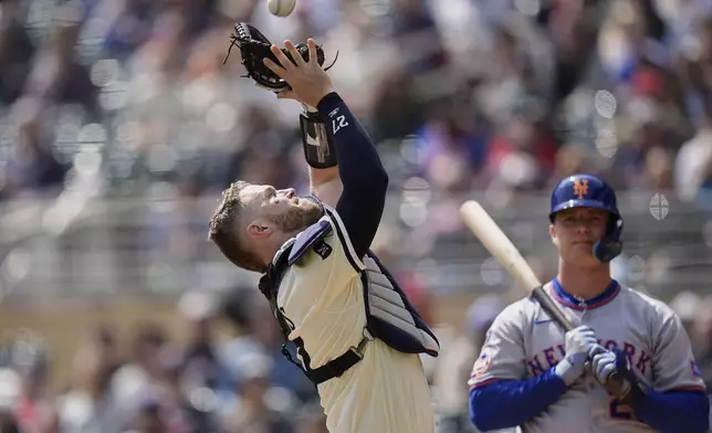 Minnesota Twins catcher Ryan Jeffers (27) catches a foul out hit by New York Mets' Pete Alonso, right, during the first inning of a baseball game Wednesday, April 16, 2025, in Minneapolis. (AP Photo/Abbie Parr)