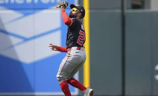 Washington Nationals shortstop Nasim Nuñez pulls in a pop fly off the bat of Colorado Rockies' Nick Martini in the second inning of Game 1 of a split baseball doubleheader Sunday, April 20, 2025, in Denver. (AP Photo/David Zalubowski)