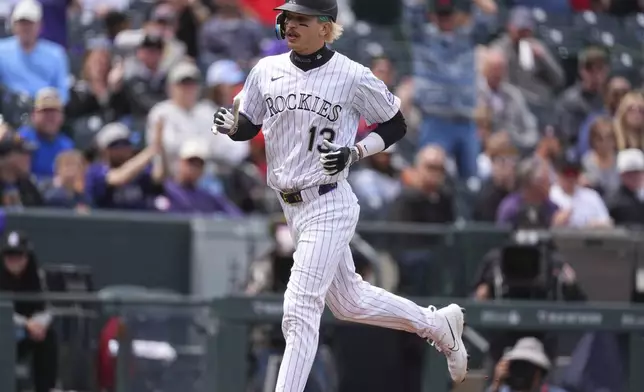 Colorado Rockies' Zac Veen circles the bases after hitting a solo home run off Washington Nationals starting pitcher Jake Irvin in the fourth inning of Game 1 of a split baseball doubleheader Sunday, April 20, 2025, in Denver. (AP Photo/David Zalubowski)