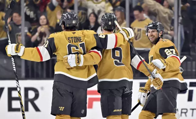 Vegas Golden Knights right wing Mark Stone (61), center Jack Eichel (9) and defenseman Shea Theodore (27) celebrate Stone's goal against the Minnesota Wild during the first period of Game 5 of a first-round NHL hockey playoff series Tuesday, April 29, 2025, in Las Vegas. (AP Photo/David Becker)